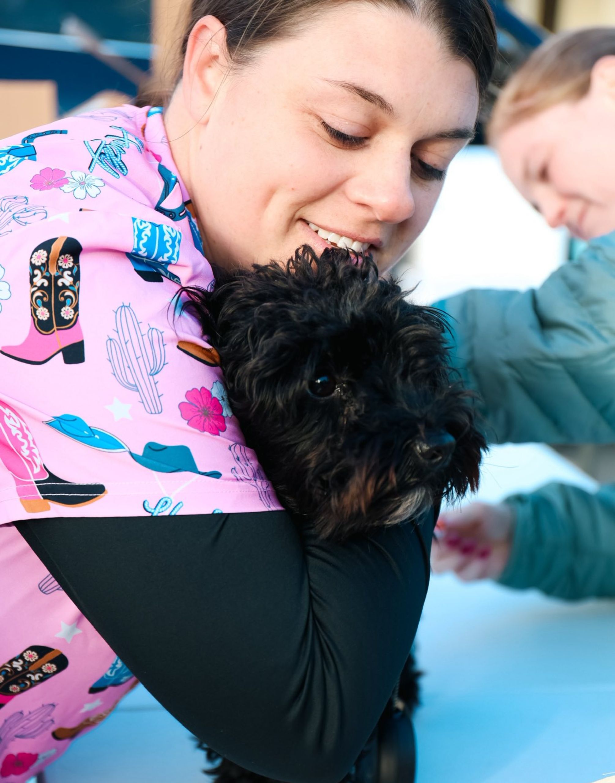 vet staff affectionately hugging a dog